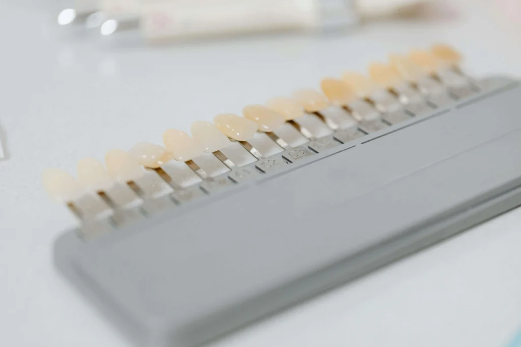 cosmetic dentist charlotte showing patient a tooth shade guide
