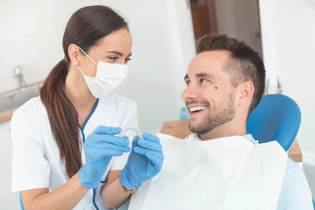 dentist showing patient what Invisalign charlotte looks like