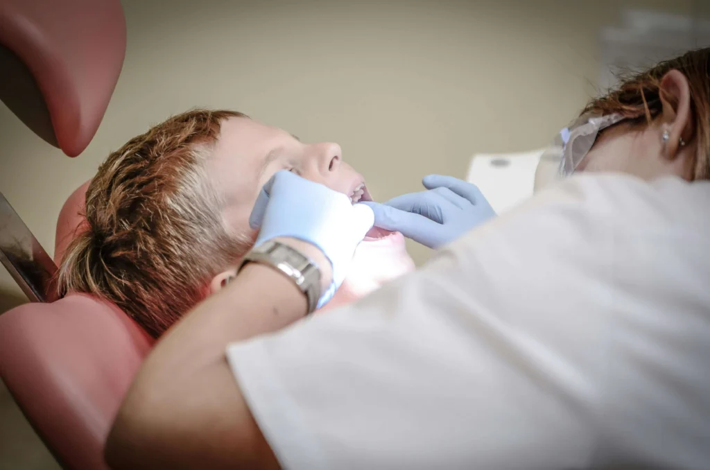 family dentist charlotte performing dental exam on a child