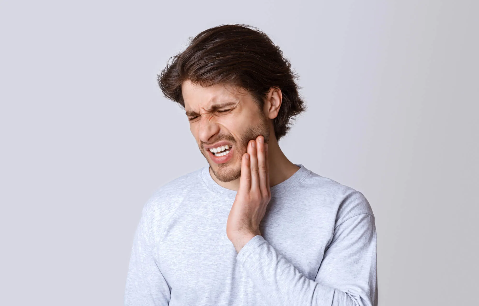 man-with-tooth-pain-needs-to-see-an-emergency-dentist-charlotte
