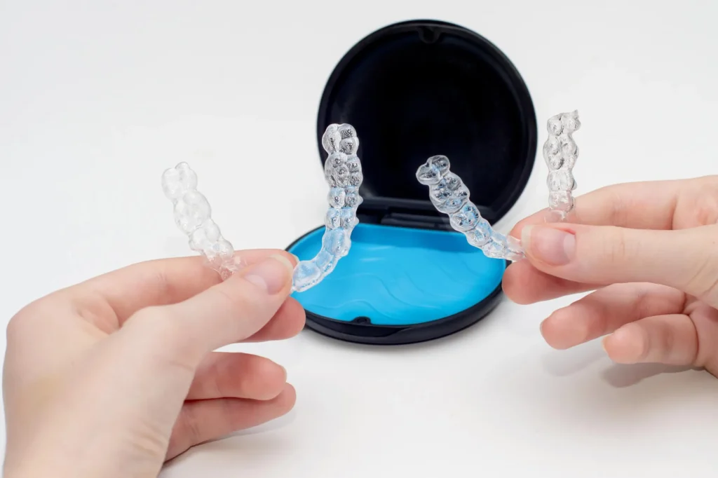 Dentist Ballantyne holding Invisalign